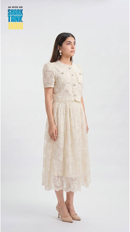Woman wearing a cream lace dress on a white background with 'Shark Tank' branding.