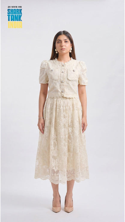 Woman wearing a cream lace dress on a white background