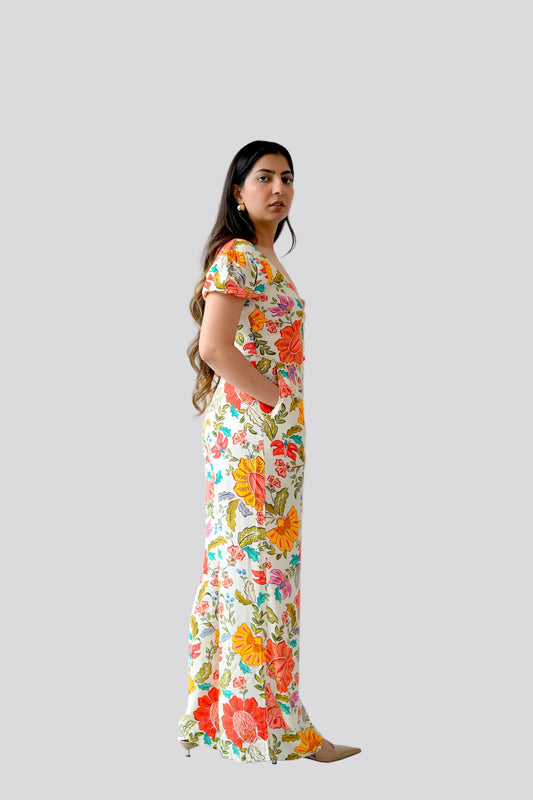 Woman wearing a floral dress on a plain background