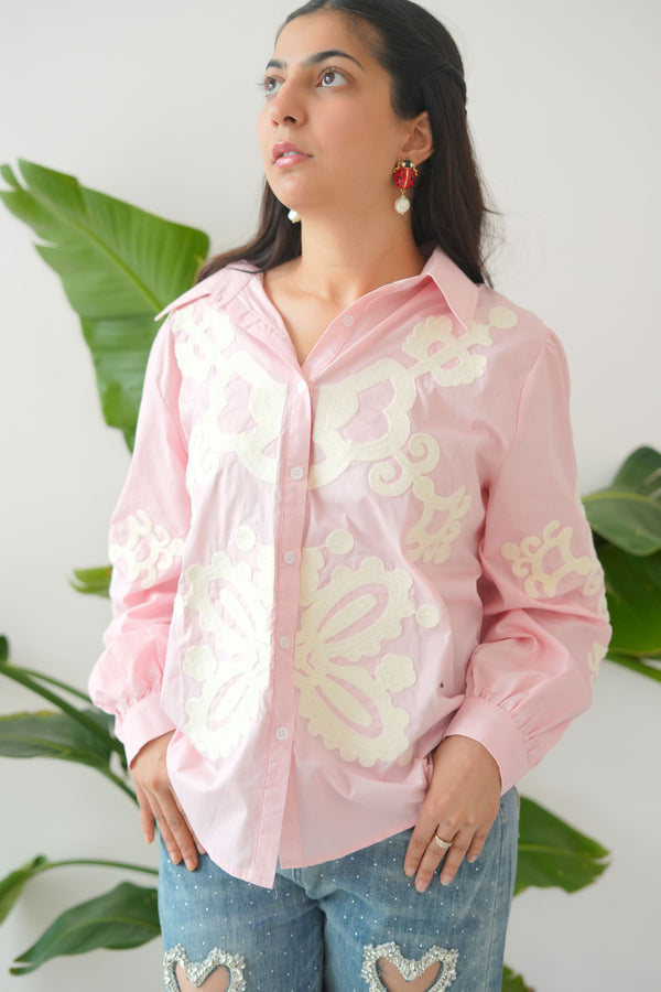 Woman wearing a pink floral dress with a white background