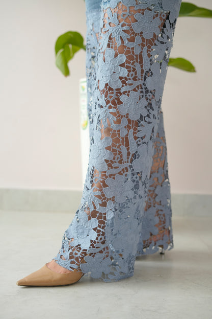 Light blue lace pants worn by a person on a light background