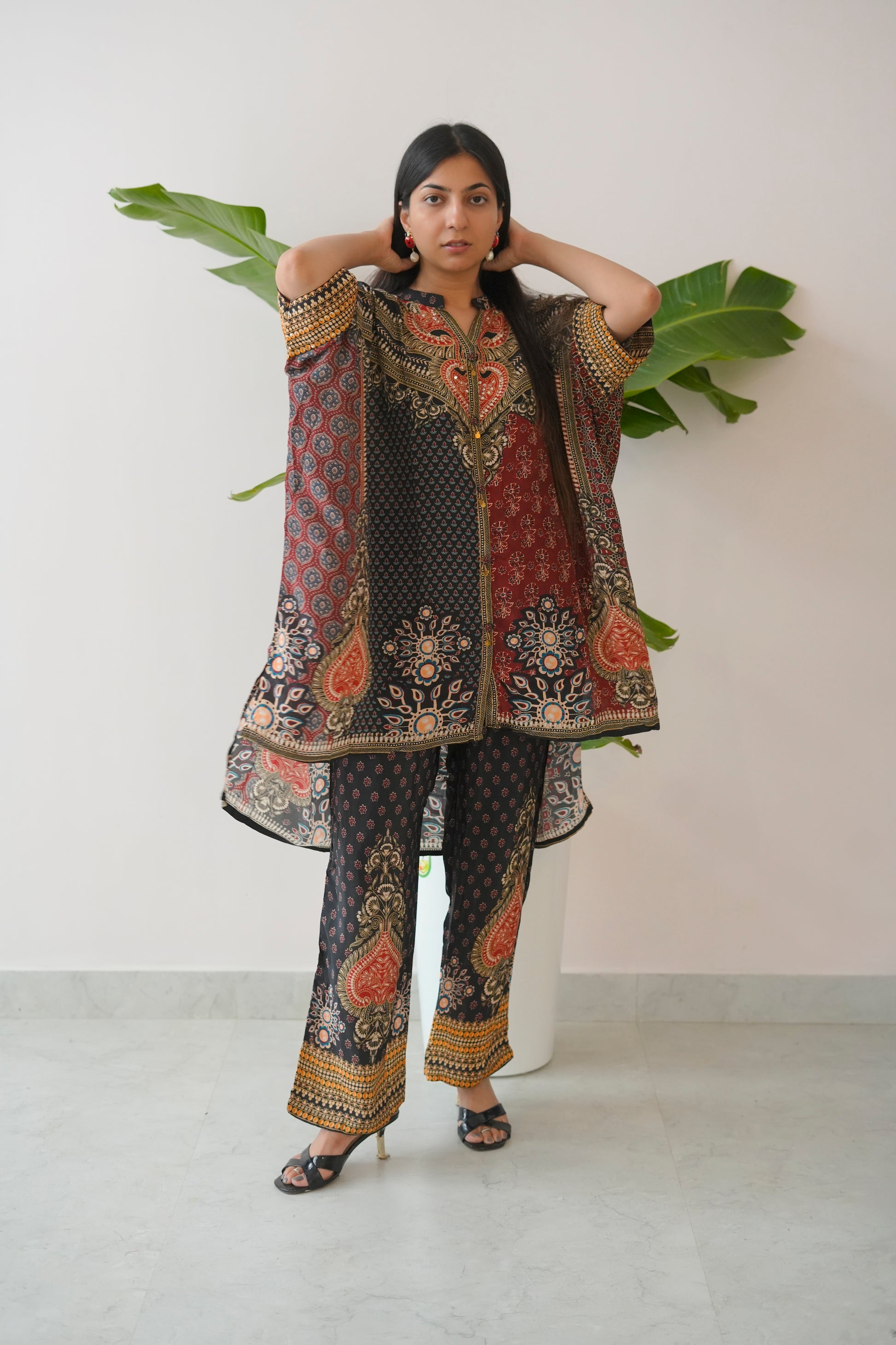 Woman wearing a traditional embroidered outfit with a white background