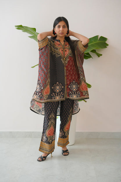 Woman wearing a traditional embroidered outfit with a white background