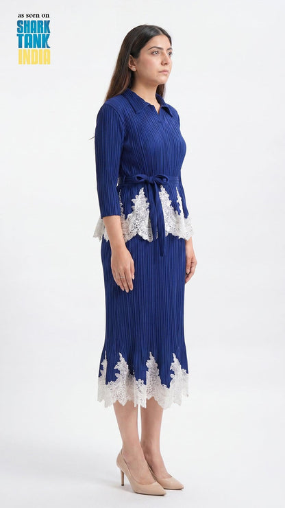 Woman wearing a blue dress with white lace details on a white background