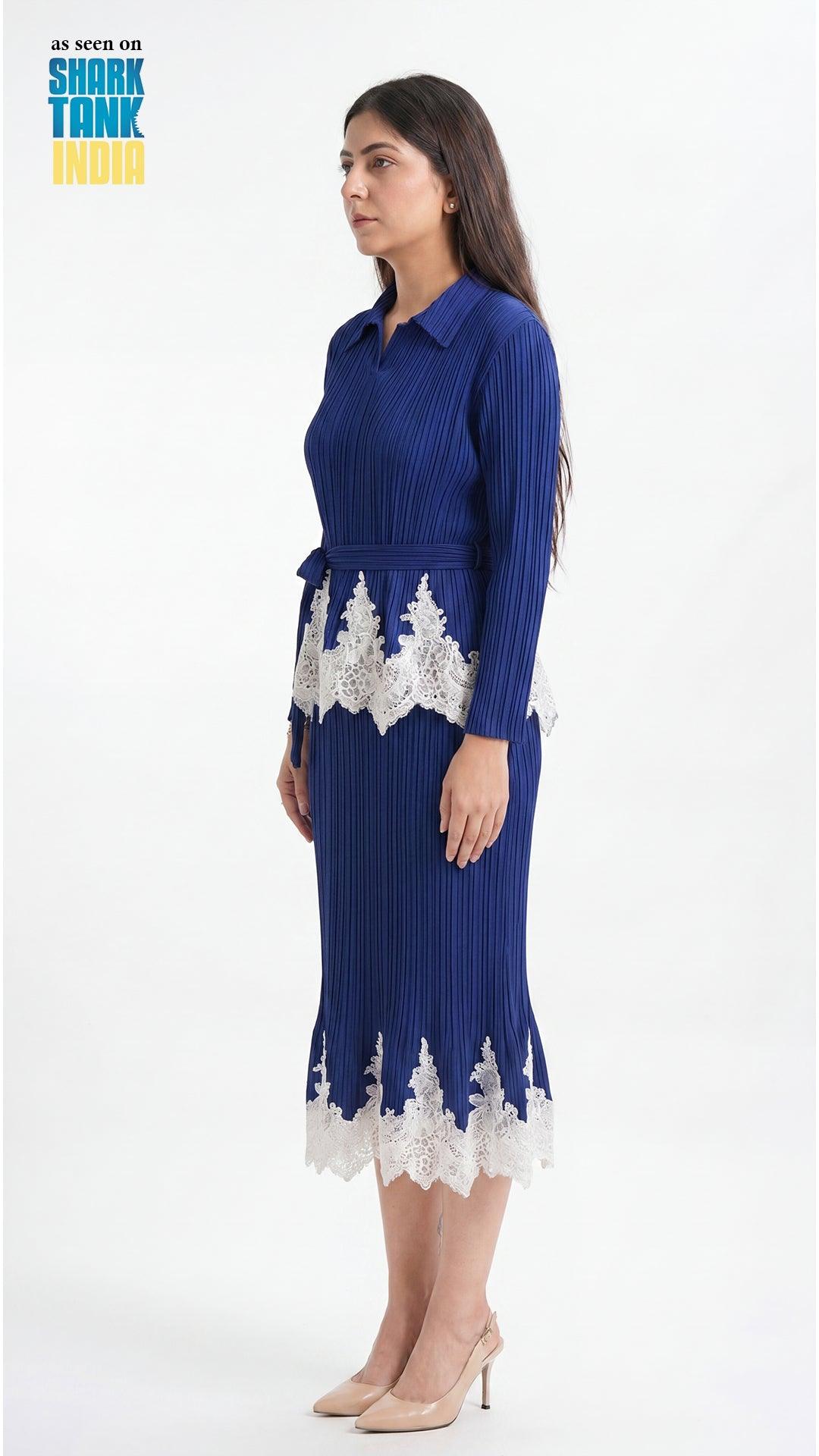 Woman wearing a blue dress with white lace details on a white background