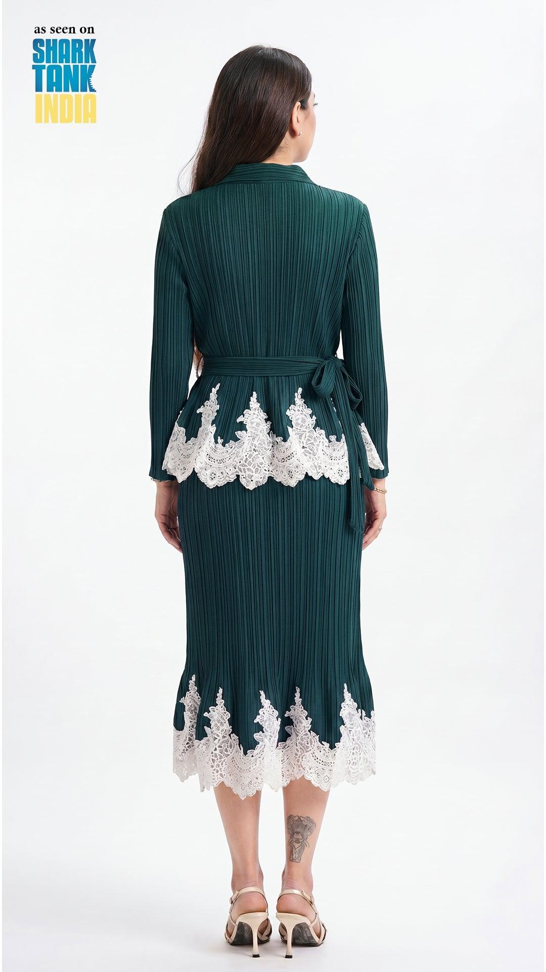 Woman wearing a dark green dress with white lace details on a white background