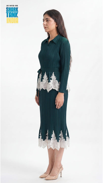 Woman wearing a green dress with white lace details on a white background