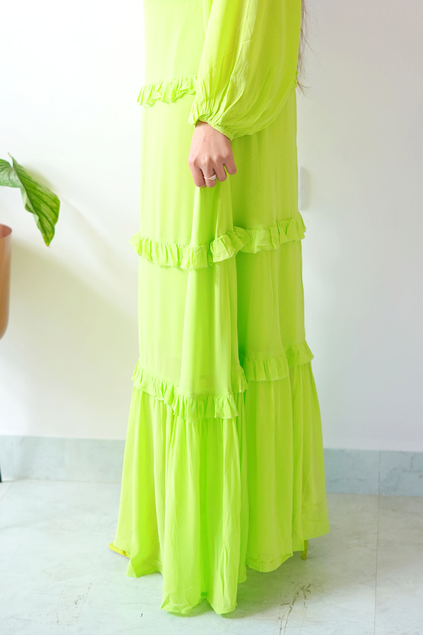 Green dress with ruffled layers on a white background