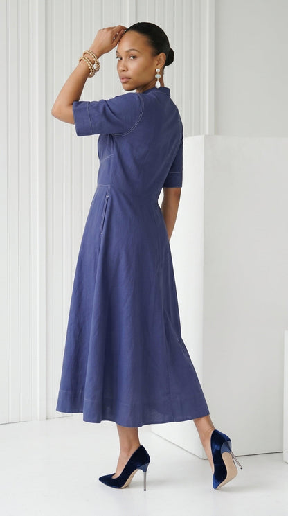 Woman wearing a blue dress with a white background