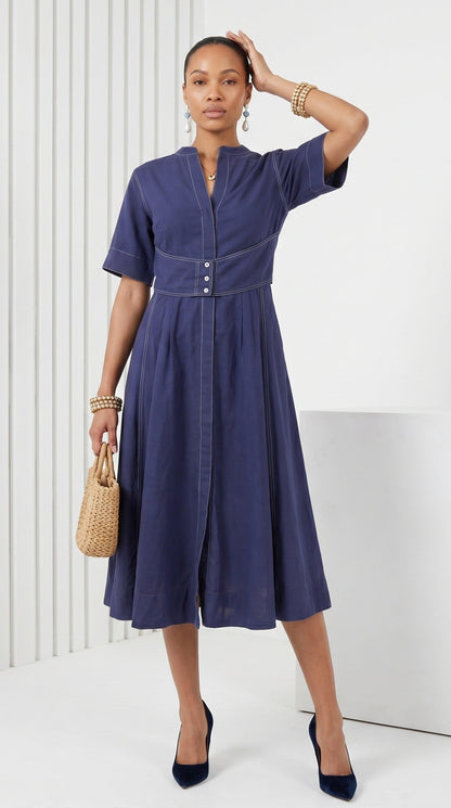 Woman wearing a blue dress with a white background