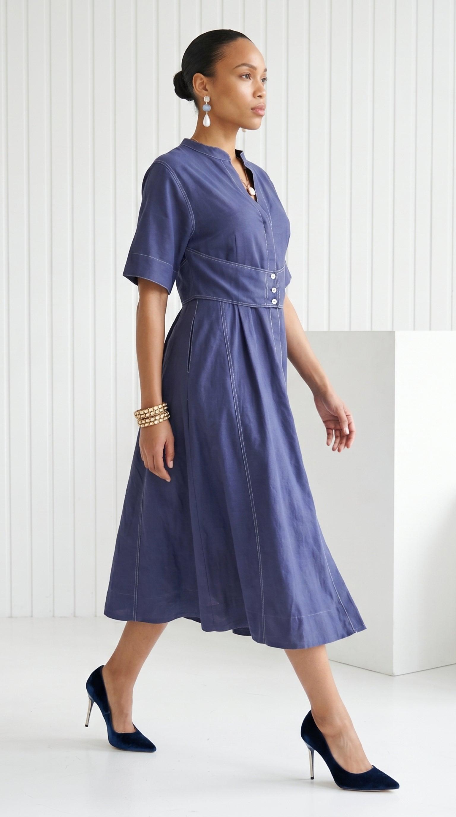 Woman wearing a blue dress with a white background