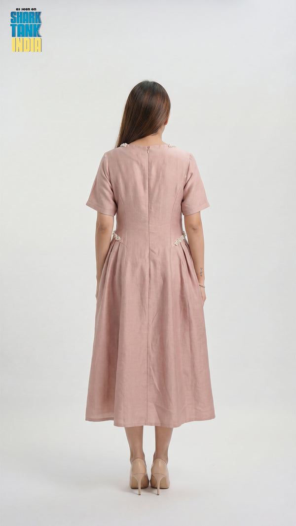 Woman wearing a pink dress from behind on a white background
