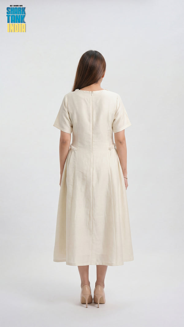 Woman wearing a beige dress on a white background