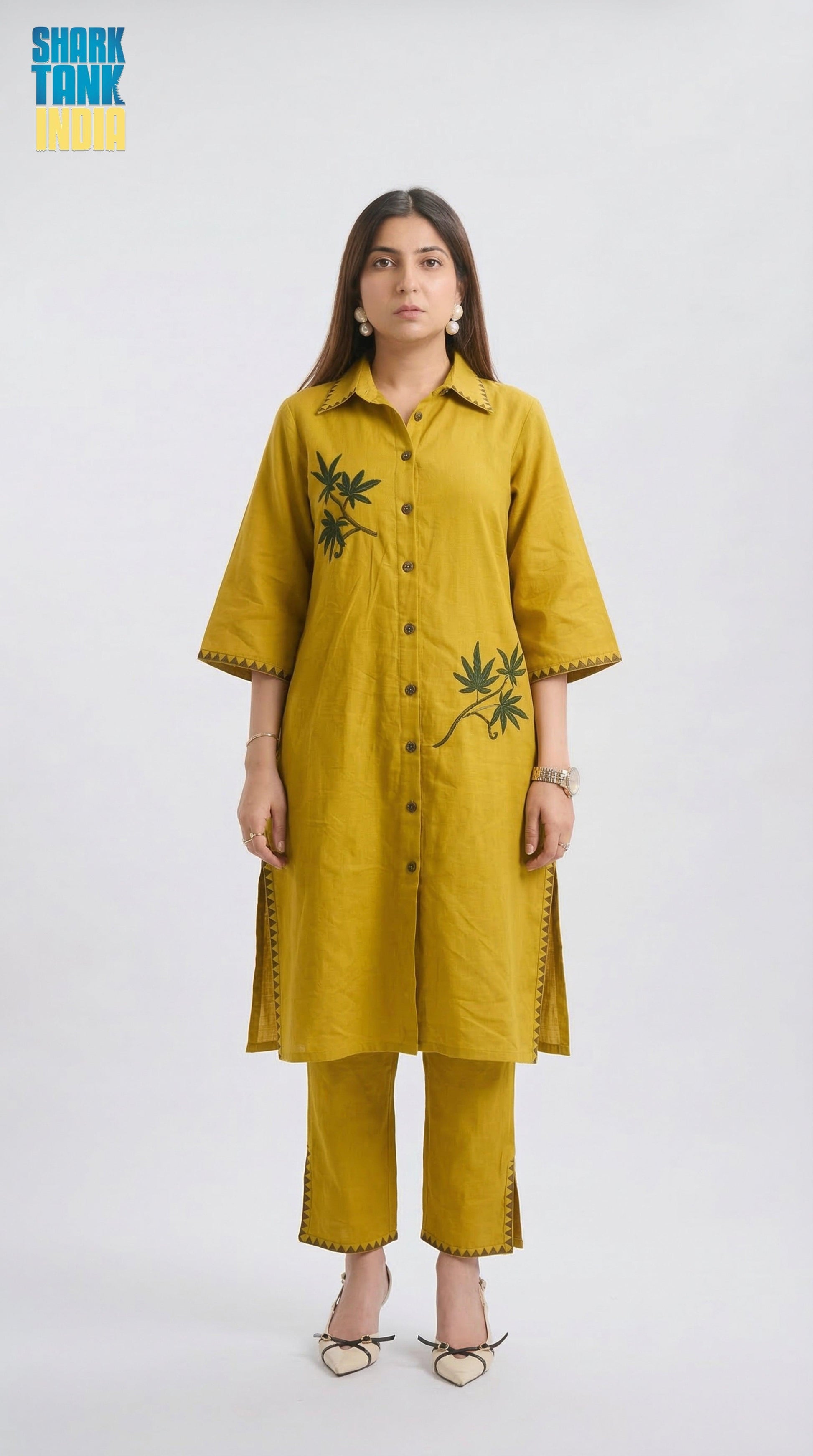 Woman wearing a mustard yellow kurta with floral embroidery on a white background
