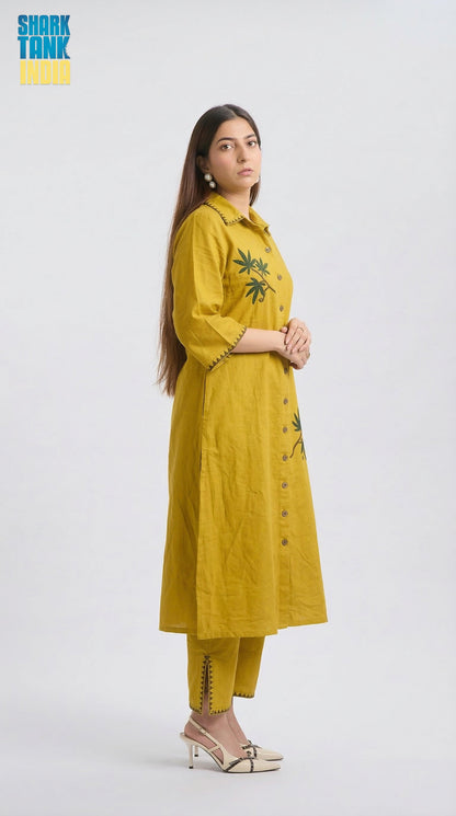 Woman wearing a yellow kurta with floral patterns on a white background