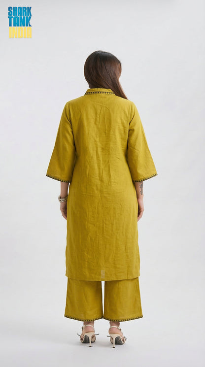 Person wearing a mustard yellow kurta with wide-leg pants on a white background