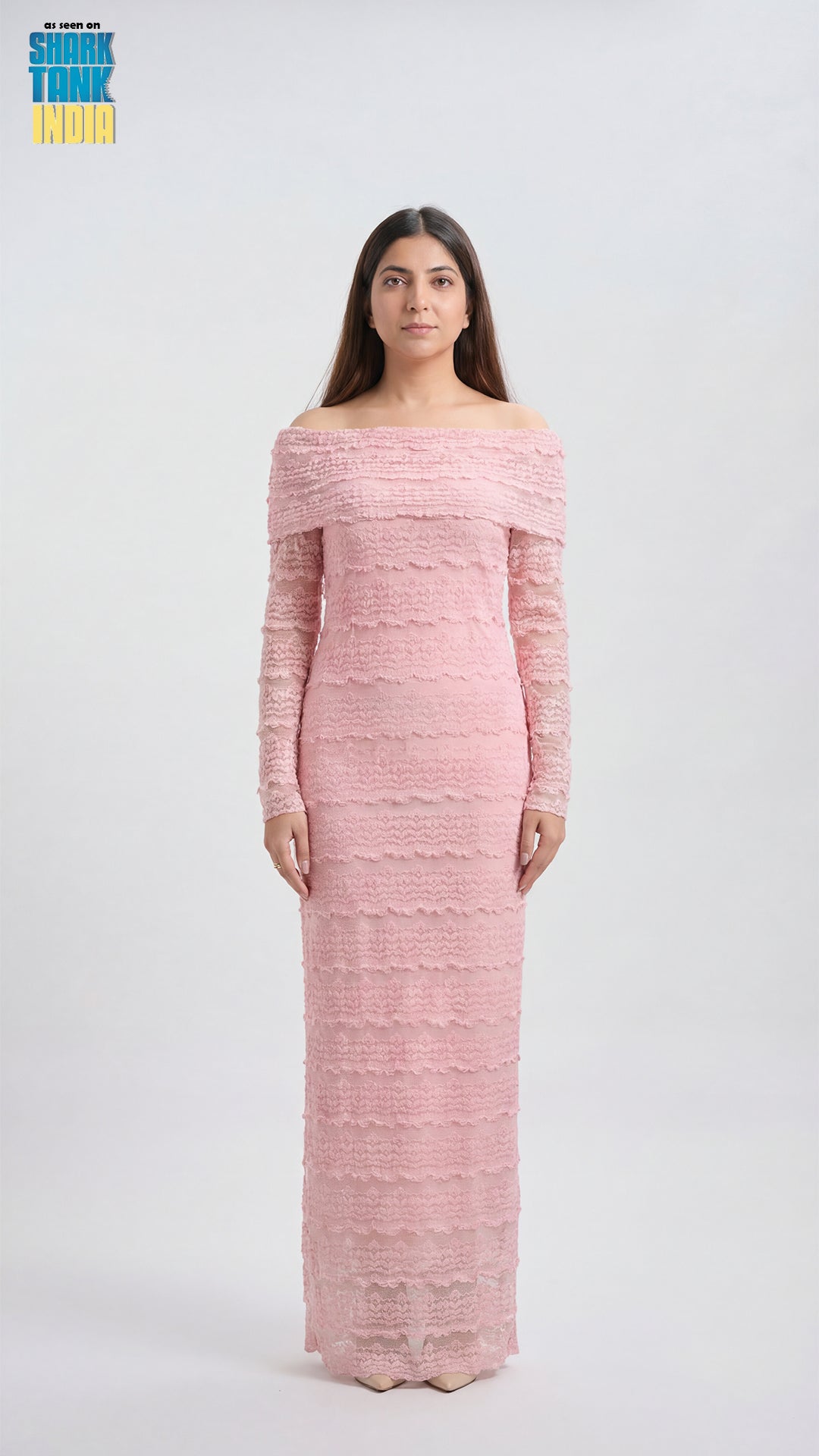 Woman wearing a pink off-shoulder long-sleeve dress on a white background