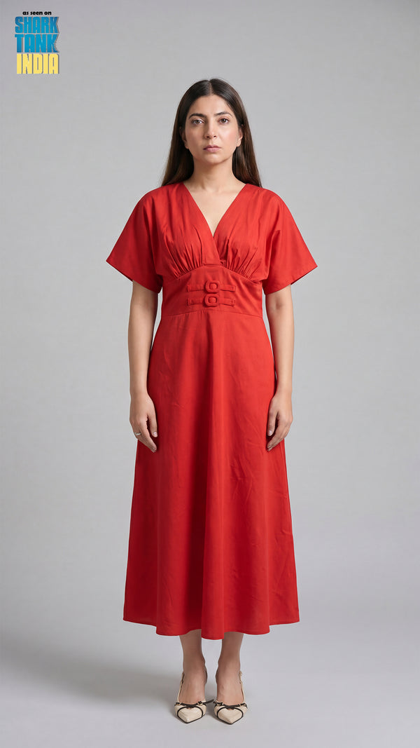 Woman wearing a red dress against a gray background