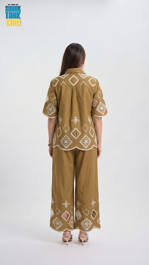 Woman wearing a patterned outfit on a white background