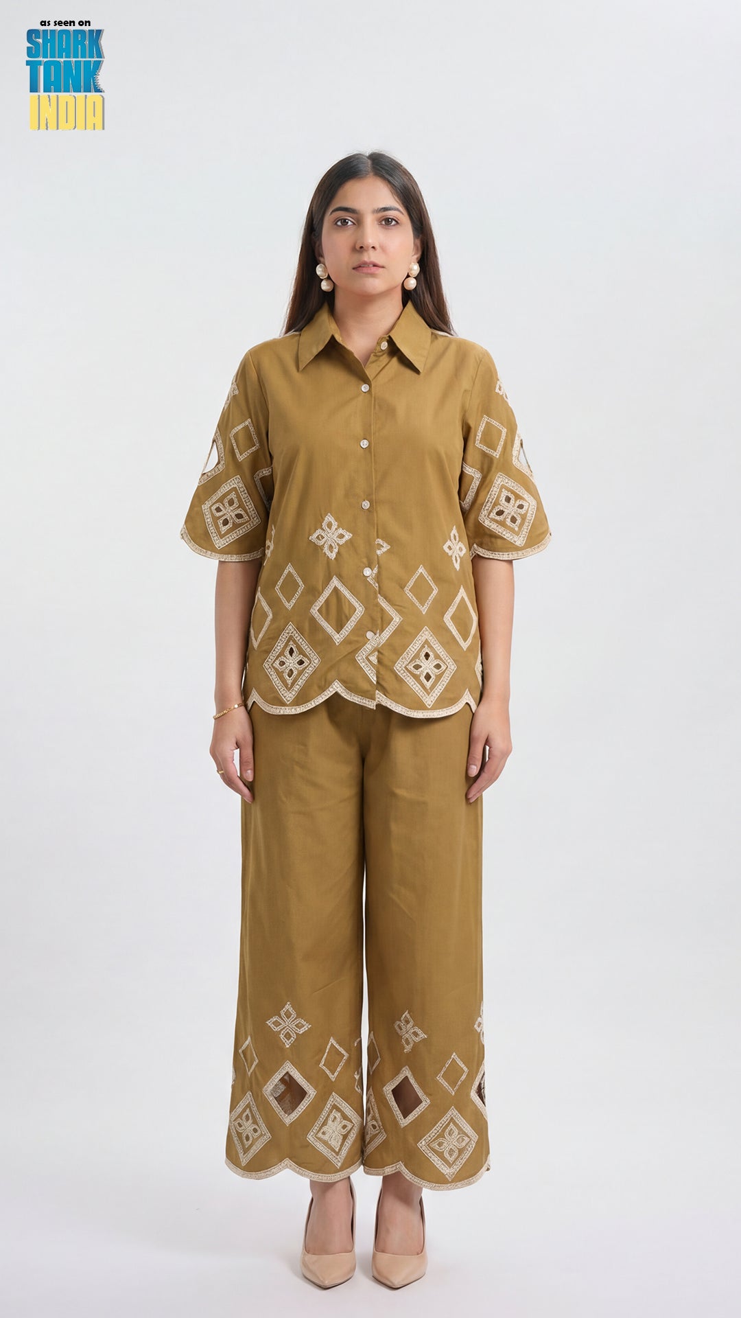 Woman wearing a mustard yellow outfit with geometric patterns on a white background