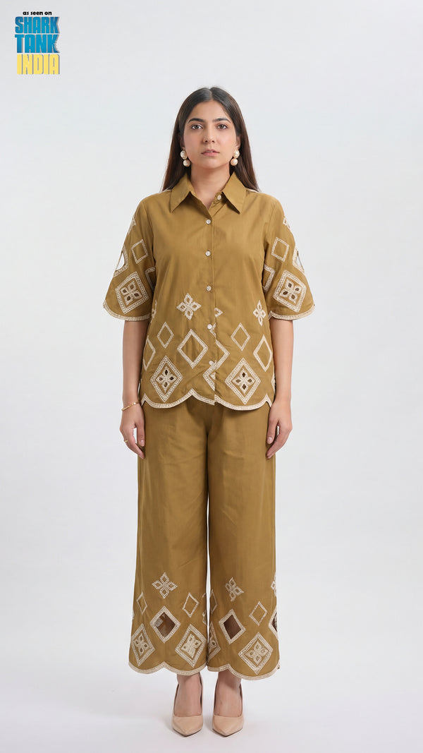 Woman wearing a mustard yellow outfit with geometric patterns on a white background