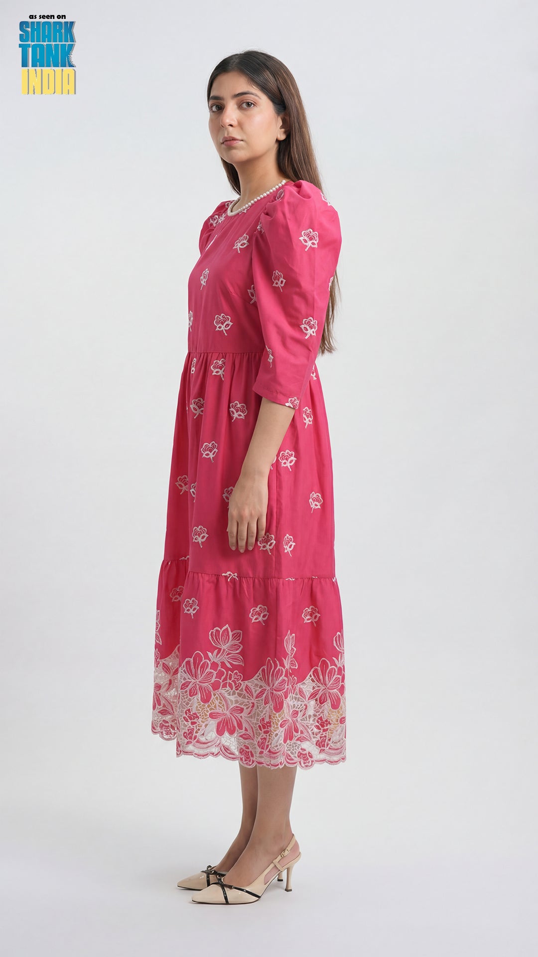 Woman wearing a pink floral dress on a white background