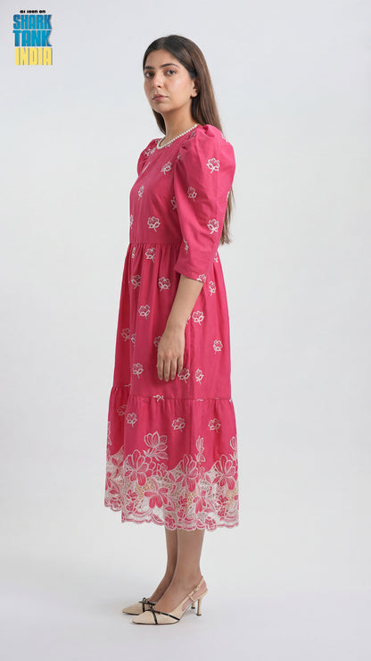 Woman wearing a pink floral dress on a white background