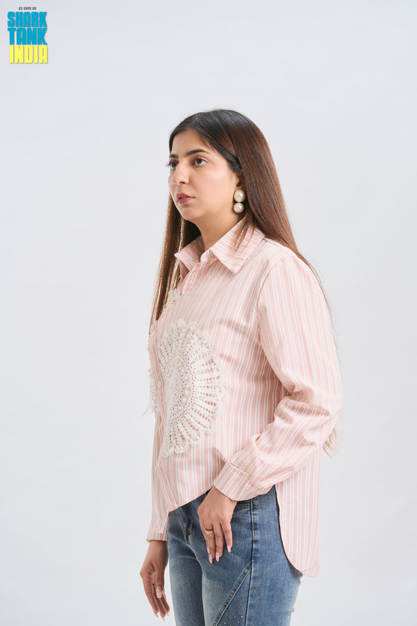 Woman wearing a light pink striped shirt and blue jeans on a white background