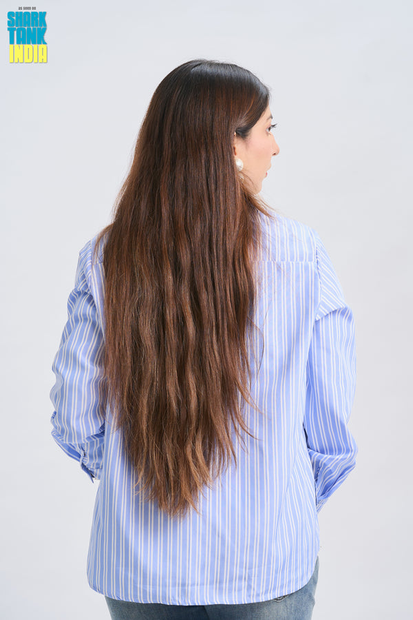 Woman with long hair wearing a blue striped shirt on a white background