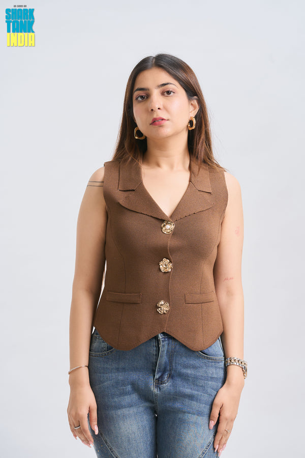 Woman wearing a brown vest with gold buttons on a white background