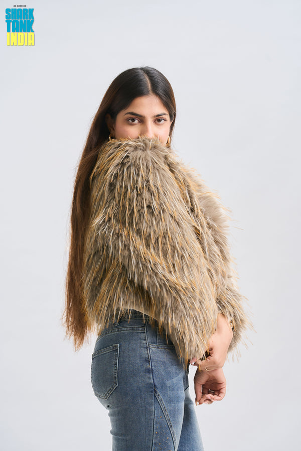 Person holding a large bundle of hair against a plain background