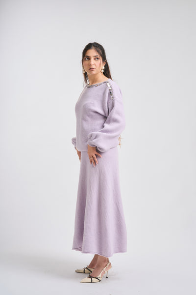 Woman wearing a light purple outfit on a white background