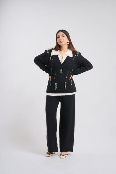 Woman wearing a black and white outfit on a white background