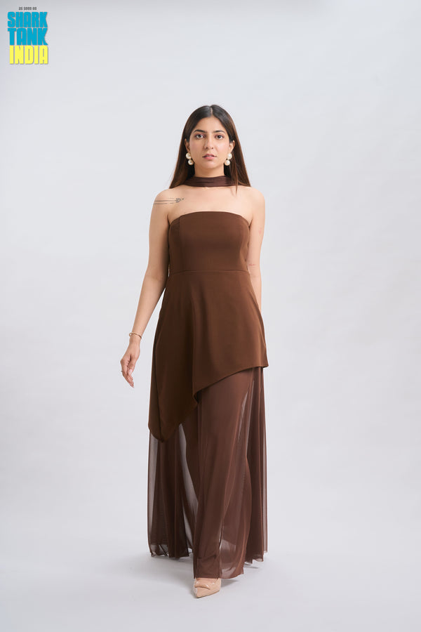 Woman wearing a brown strapless dress with sheer overlay on a white background