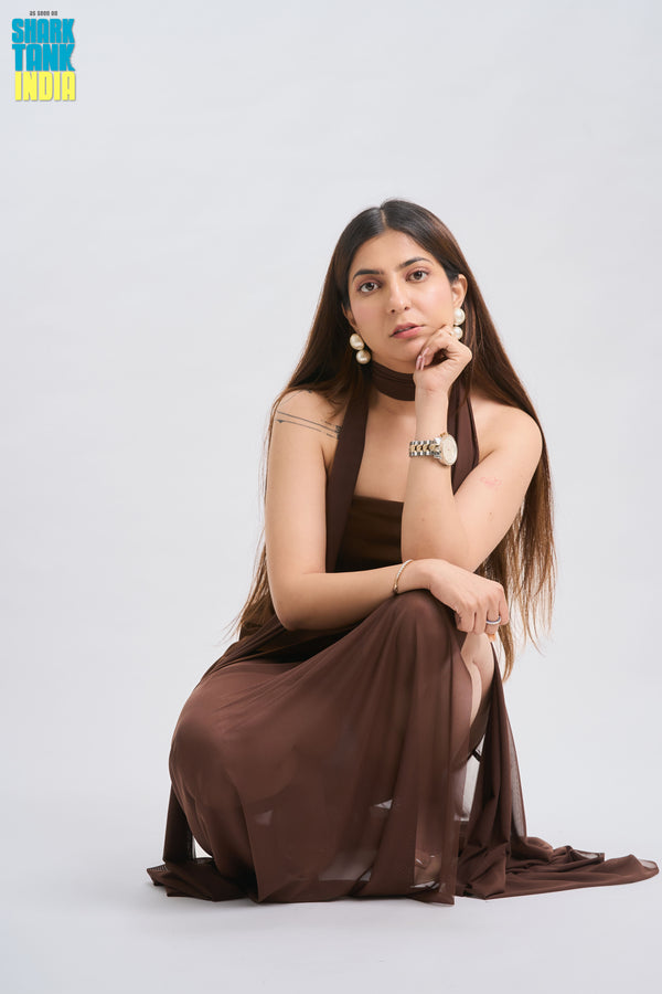 Woman in a brown dress posing on a white background