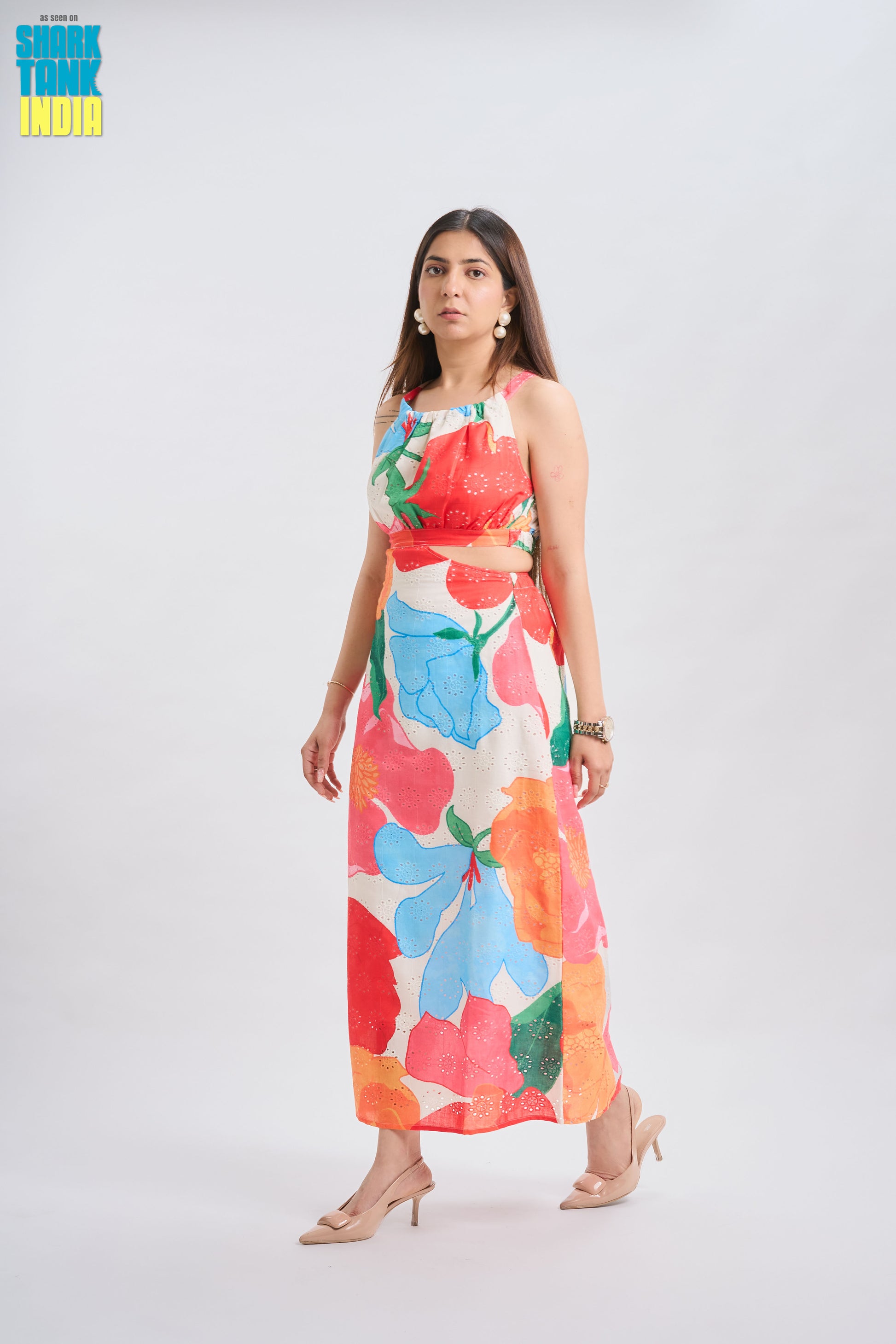 Woman wearing a colorful floral dress on a white background