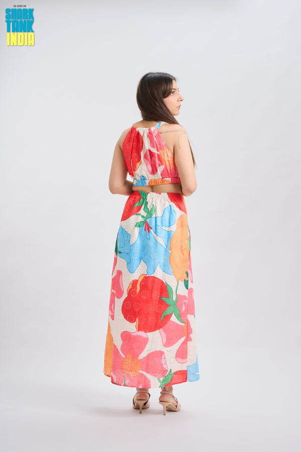 Woman wearing a colorful floral dress on a white background