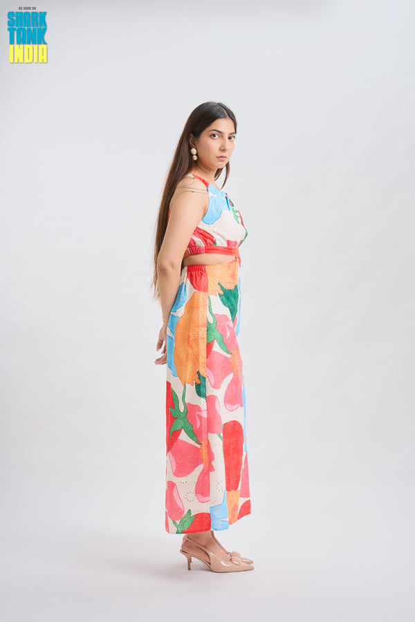 Woman wearing a colorful floral dress on a white background