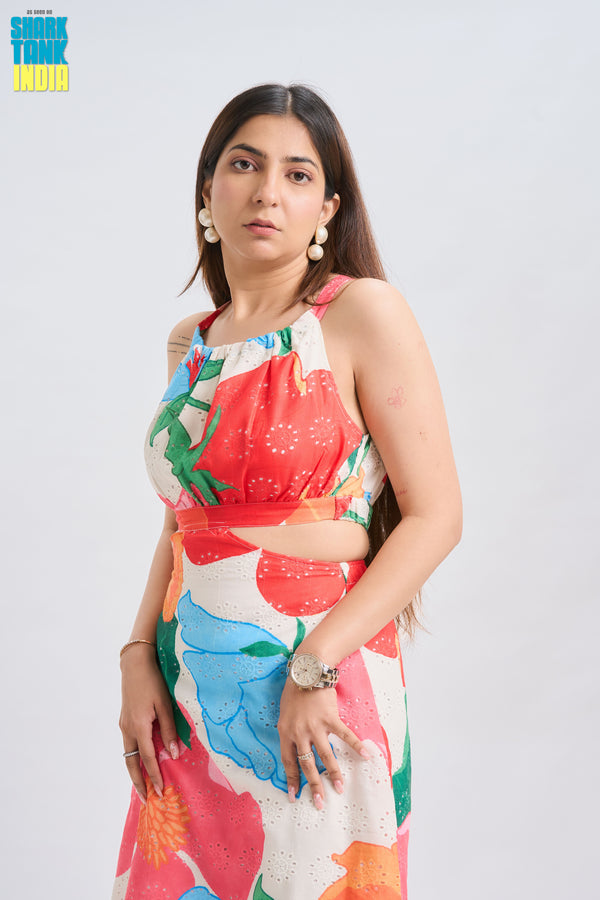 Woman wearing a colorful floral dress on a light gray background