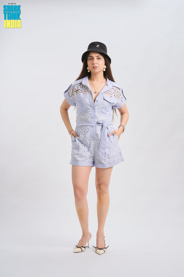 Woman wearing a light blue outfit with a hat on a white background