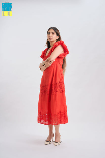 Woman wearing a red dress with ruffled sleeves on a white background