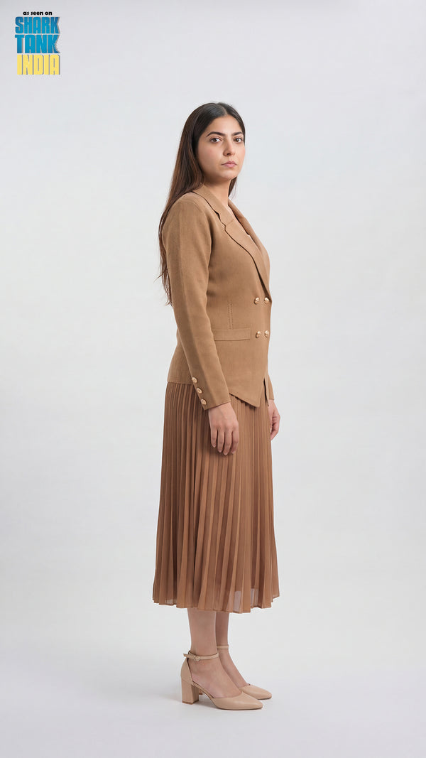 Woman wearing a beige suit with a pleated skirt on a white background