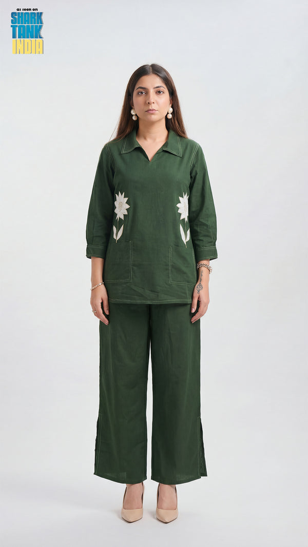 Woman wearing a green outfit with floral patterns on a white background