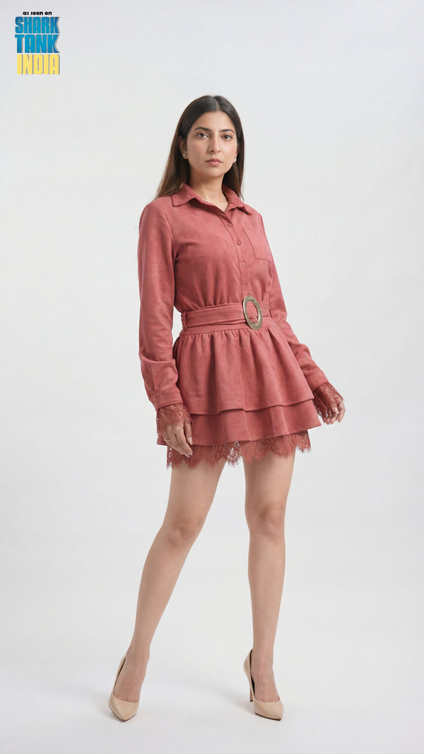 Woman wearing a pink dress with a belt on a white background