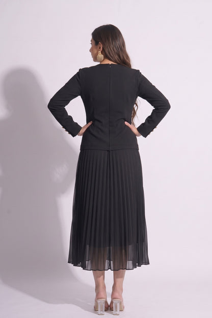 Woman wearing a black outfit with a jacket and pleated skirt on a white background