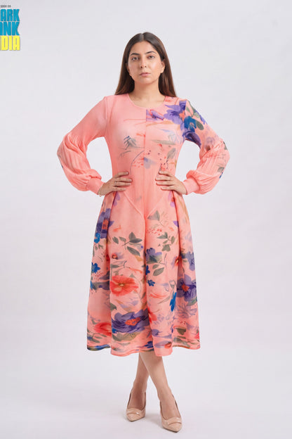 A woman modeling a peach pink long-sleeve kurta with a colorful floral print, standing against a light gray studio background.