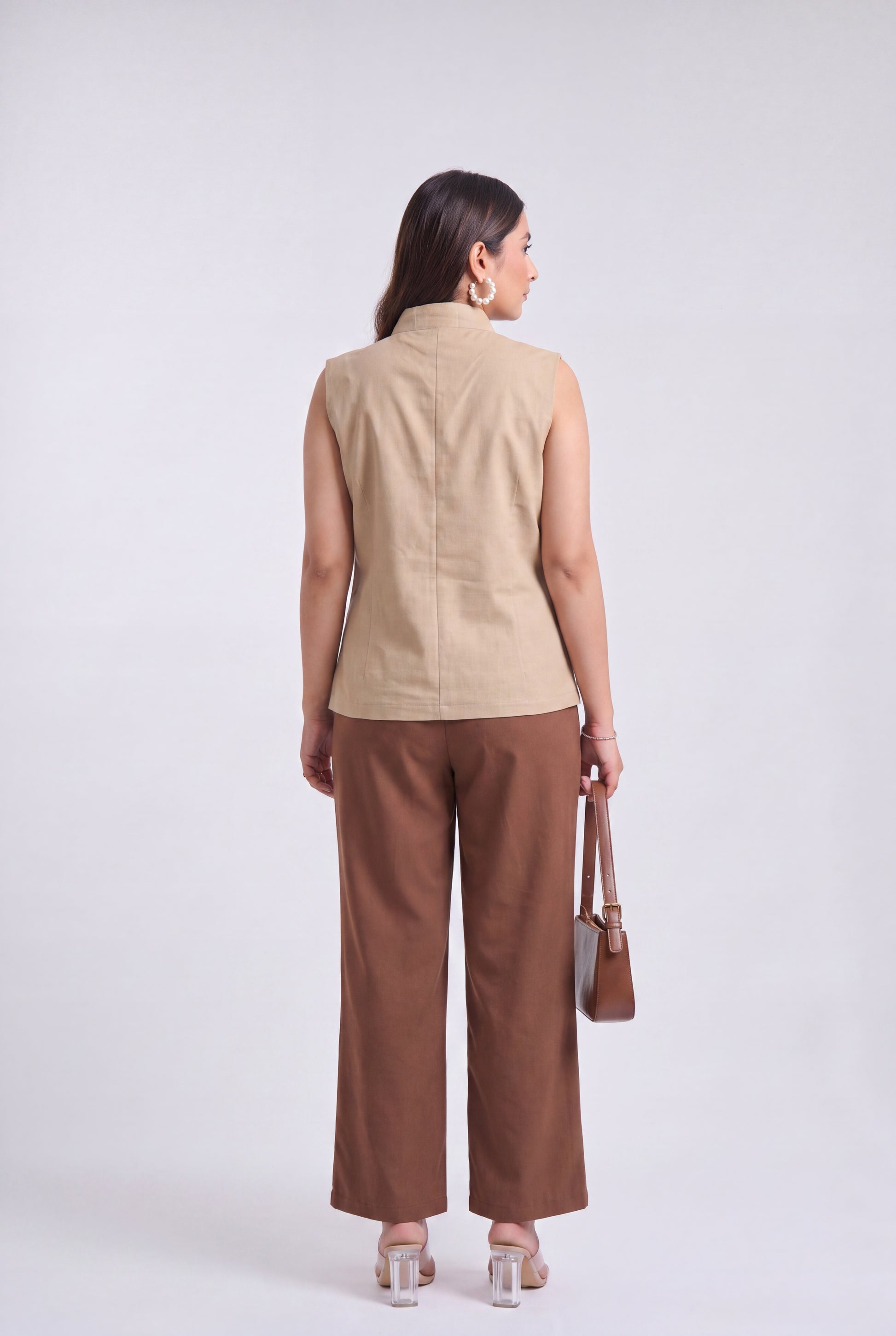 Tbfo Nepolian Top in beige with military-inspired metallic button detailing and high stand collar