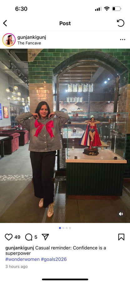 Person standing in a museum-like setting with a display case and statue.