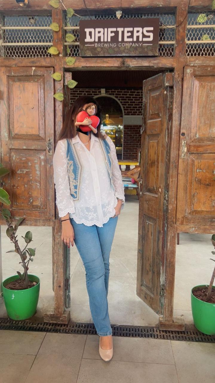 Woman standing in front of a wooden door with 'Dafters Brewing Company' sign