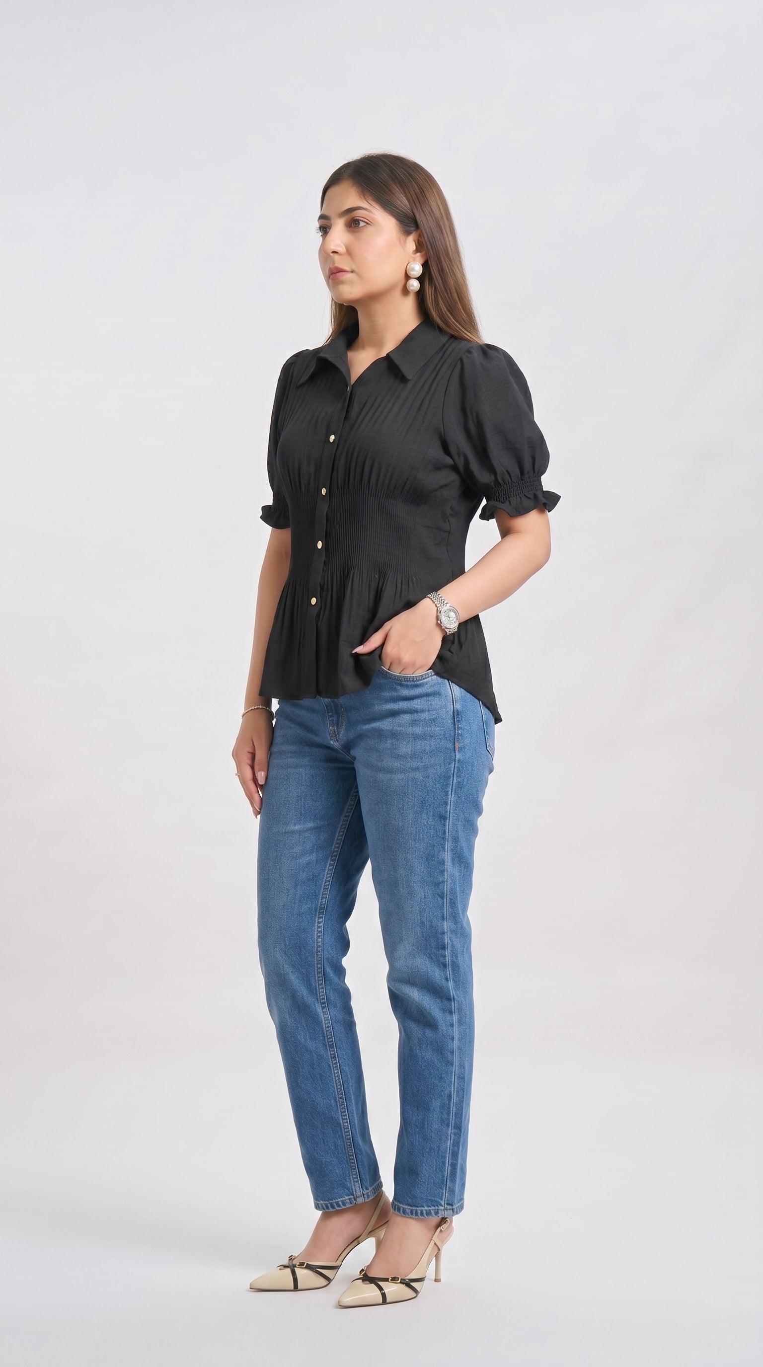 Woman wearing a black blouse and blue jeans on a white background